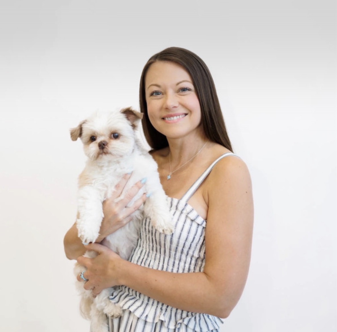 Kara Zahasky smiling and holding her dog